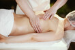 © Alliance - massage therapist in massage cabinet massaging client