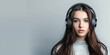 photo of a nice-looking girl in large headphones on a light background with copy space on the left, banner