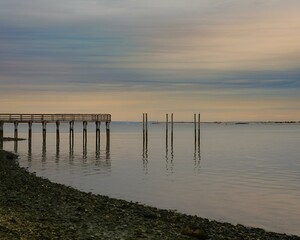 Canvas Print - Pier at sunset surrounded by serene waters