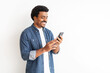© Prostock-studio - Joyful young black man in denim engaging with smartphone