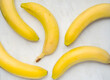 Bananas on white marble background top view