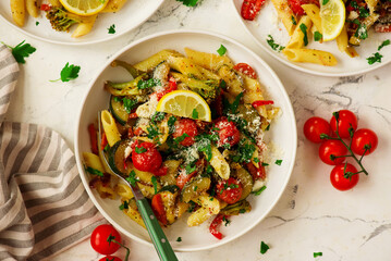 Poster - Pasta Primavera, vegetables pasta with zuccini, tomato  and lemon .top veiw.selective focus