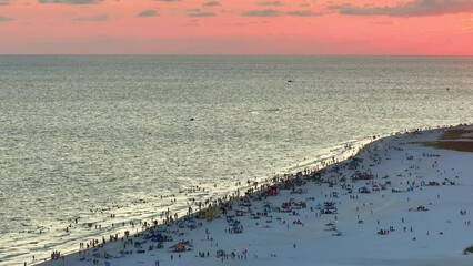 Wall Mural - Crowded Siesta Key beach in Sarasota, USA. Many people enjoying vacations time swimming in ocean water and relaxing on warm Florida sun at sundown