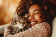 A black woman hugs her grey tabby cat.