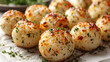Golden roasted potatoes garnished with herbs on a plate, perfect for culinary themes.