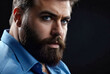 Portrait of brutal, bearded, aggressive, big person in blue shirt on dark background. Angry human bodyguard with stern look. Mafia man is ready to protect against violence and underground. Copy space