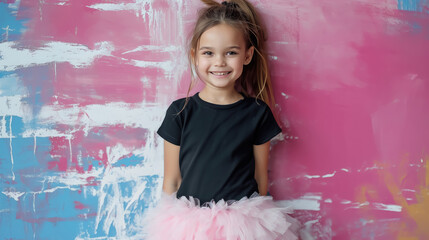 Wall Mural - studio photo of a small smiling stylish girl in a fluffy skirt and T-shirt on a color background, child, children, toddler, baby, kid, clothing, emotional face, expression, joy, smile, fun, pink