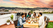 © Davide Angelini - Happy friends having barbecue dinner party at home balcony - Young people enjoying lunch break at restaurant terrace
