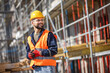 © Mediteraneo - Construction site manager standing  wearing safety vest and helmet, thinking at construction site. Young architect watching construction site with confidence.