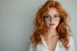 © Halise - Beautiful red-haired woman with glasses.