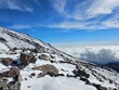 Snowy Mountain Peaks in Winter with View of Clouds and Sky