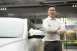 Confident businessman at car dealership