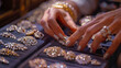 A woman's hands selecting jewelry from a display.