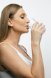 © zinkevych - Close up of a young woman drinking water