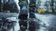 A detailed closeup of a rain-soaked boot treading carefully on a clean sidewalk near a muddy puddle, capturing the essence of resilience amidst adversity