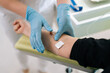 © dikushin - High-angle view of skilled nurse giving intravenous infusion to female patient in clinic. Medical worker in uniform inserting IV line needle in vein of woman at hospital. Medicine, vitamin therapy.