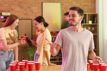 Poster - Young man with ball for beer pong at party