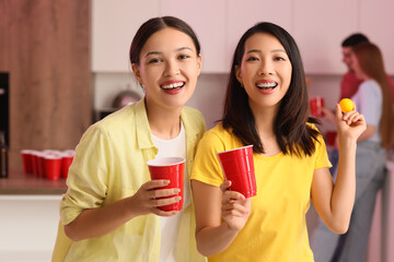 Poster - Female friends with cups and ball for beer pong at party