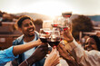 © Davide Angelini - Happy friends toasting red wine glasses at rooftop house party - Men and women having bbq dinner party outside