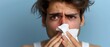 unglücklicher europäischer Mann mit laufender Nase, hält Nasentropfen und Taschentuch in der Hand, leidet an allergischer Rhinitis, hat tränende rote Augen, krank, Konzept Heuschnupfen