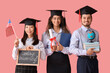 Graduate students holding chalkboard with text GOODBYE UNIVERSITY, diploma and USA flag on pink background