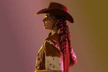 Poster - Beautiful young woman with braids and cowboy hat on light background