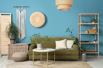 Wall Mural - Stylish interior of blue living room with bamboo stems and sofa