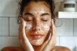 A woman engaged in her skincare routine, gently massaging an exfoliating scrub onto her face. 