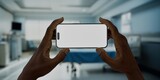 Fototapeta  - Black African-American male using smartphone with a blank screen in hospital