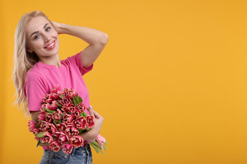 Wall Mural - Happy young woman with beautiful bouquet on orange background. Space for text