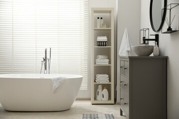 Poster - Stylish bathroom interior with grey chest of drawers and shelving unit