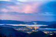 View of city, town in valley at dawn, dusk, sunrise, sunset