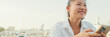 © Andrii Nekrasov - Smiling young woman using mobile phone on seascape background, Panorama