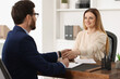 © New Africa - Lawyer shaking hands with client in office, selective focus