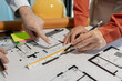 © Chadaporn - An engineer works with an architect to study the specifics of construction blueprints and use various tools to find the information, Compasses and rulers for design work
