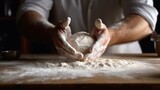 Fototapeta  - Male hands kneading dough on wooden table in kitchen, closeup