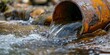 © tashechka - Close-up of a rusty pipe with water flowing out of it
