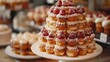   A white plate topped with plenty of donuts, coated with frosting and crowned with raspberry toppings