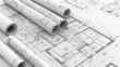 © phairot - Architectural Blueprints of Building Design. An array of rolled and unrolled architectural blueprints featuring detailed building plans, highlighting the precision of engineering design.