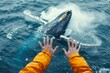 A person's hands raised in awe as they watch a whale breach the surface of the frigid sea, capturing the exhilarating moment of connection between human and marine life