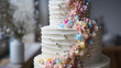 A decadent birthday cake covered in smooth pastel-colored buttercream