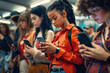 © AiCreator - group of diverse teenage group of young people using phone, immersed in their smartphones at public transportation station