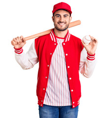 Wall Mural - Young handsome man holding baseball bat and ball looking positive and happy standing and smiling with a confident smile showing teeth
