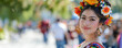Cinco de Mayo concept - beautiful young Mexican female wearing national costume during outdoor fiesta celebration