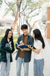 © Nuttapong punna - Young Asian college students and a female student group work at the campus park