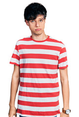 Sticker - Handsome hipster young man wearing casual striped t shirt depressed and worry for distress, crying angry and afraid. sad expression.