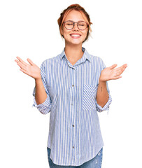 Poster - Young redhead woman wearing casual clothes and glasses celebrating mad and crazy for success with arms raised and closed eyes screaming excited. winner concept