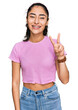 Hispanic teenager girl with dental braces wearing casual clothes showing and pointing up with fingers number two while smiling confident and happy.