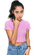 © Krakenimages.com - Hispanic teenager girl with dental braces wearing casual clothes pointing to the eye watching you gesture, suspicious expression