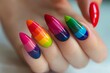 Vibrant and trendy rainbow striped stiletto manicure nail art for fashionable and creative female hands